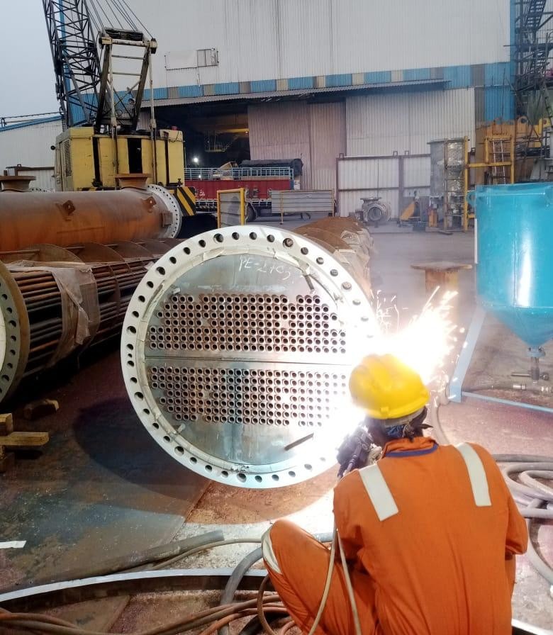 Heat exchanger tube sheet coating